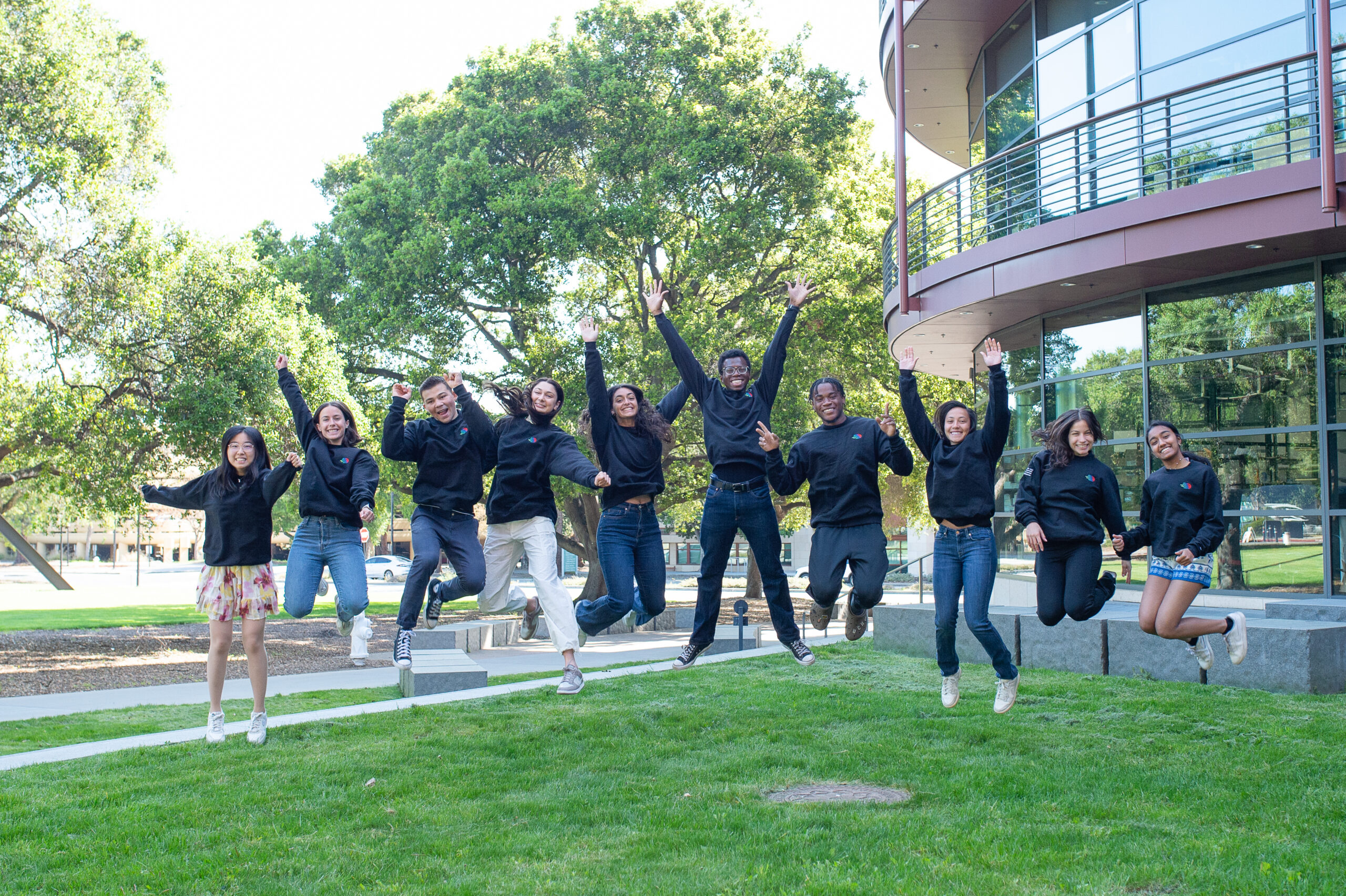 10 undergraduate scholars jumping outside