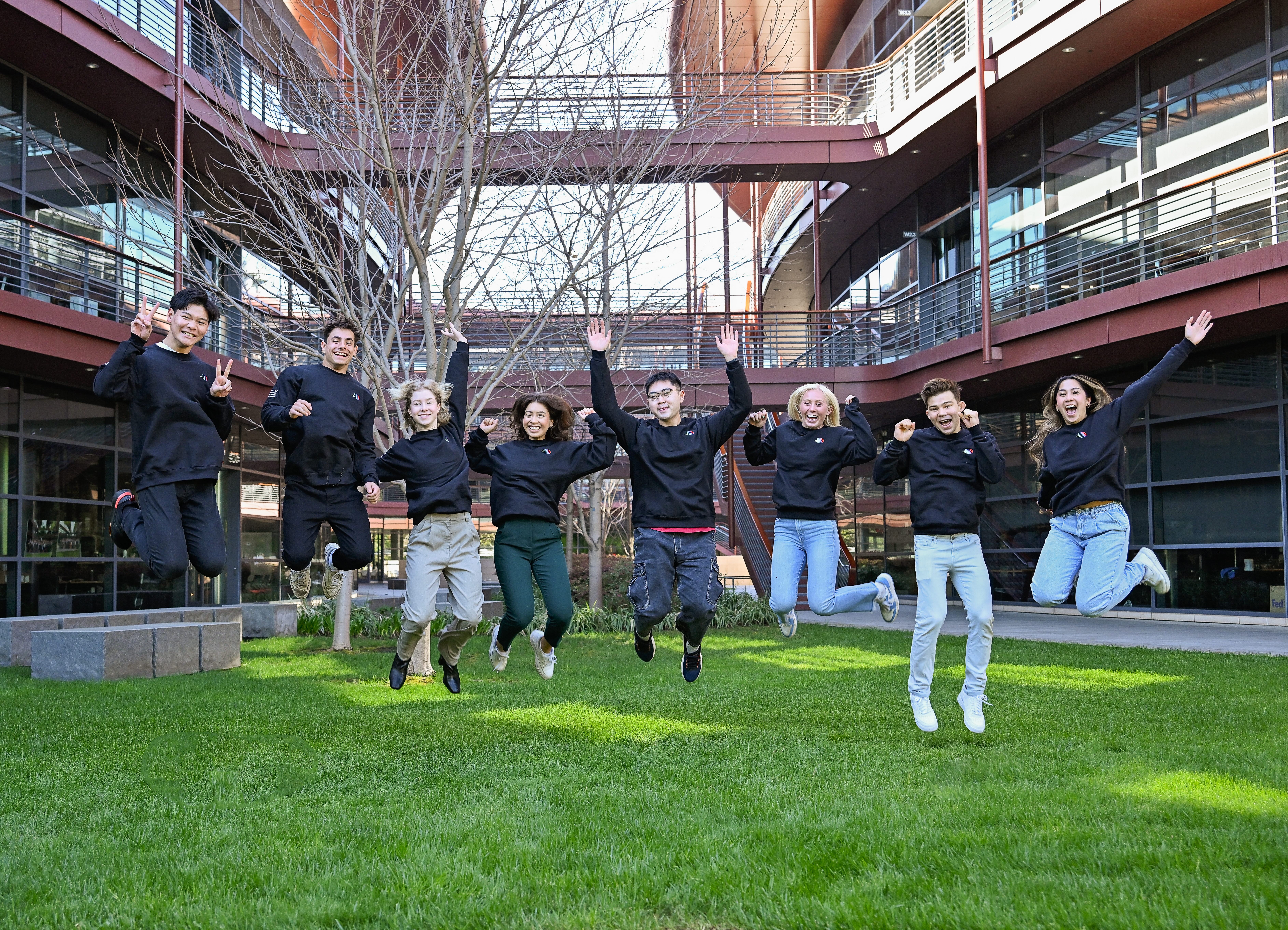 undergraduate research scholars jumping in the air